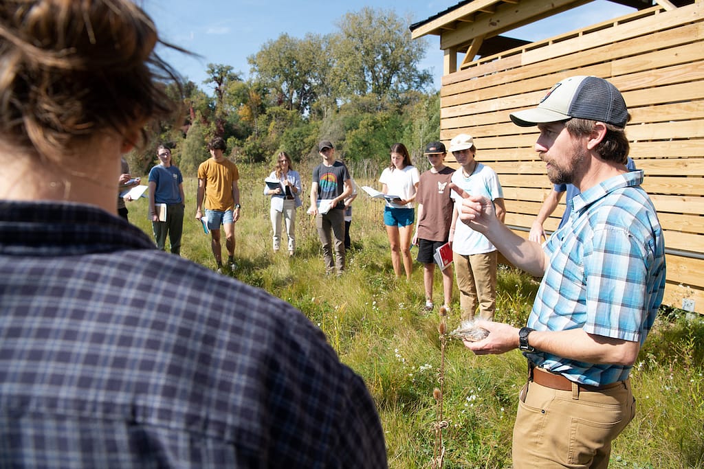 Class gathered in front of outdoor classroom.