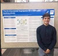 Colin Gaunt in front of poster presentation