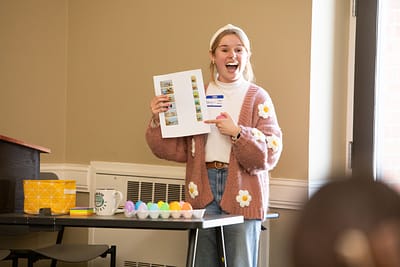 Saint Michael's College student Amy Hylen holds up a poster.