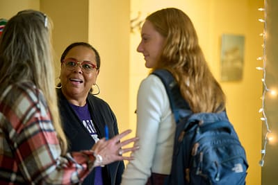 Saint Michael's College staff member Vernita Weller, center, speaks with Saint Michael's College students. 