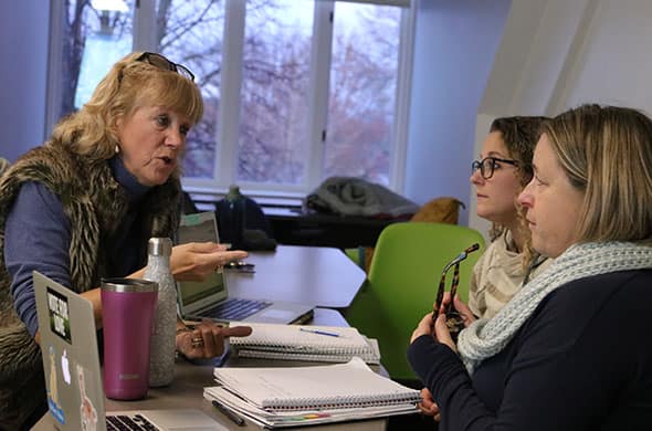 A Professor talks to students in a Graduate Education classroom. 