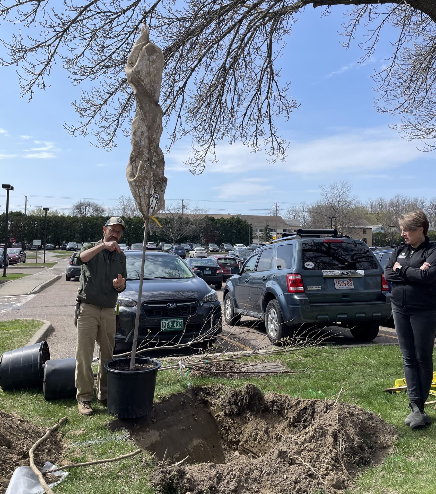 Professor Trevien Stanger leads a group of campus community members to plant a tree on Earth Day.
