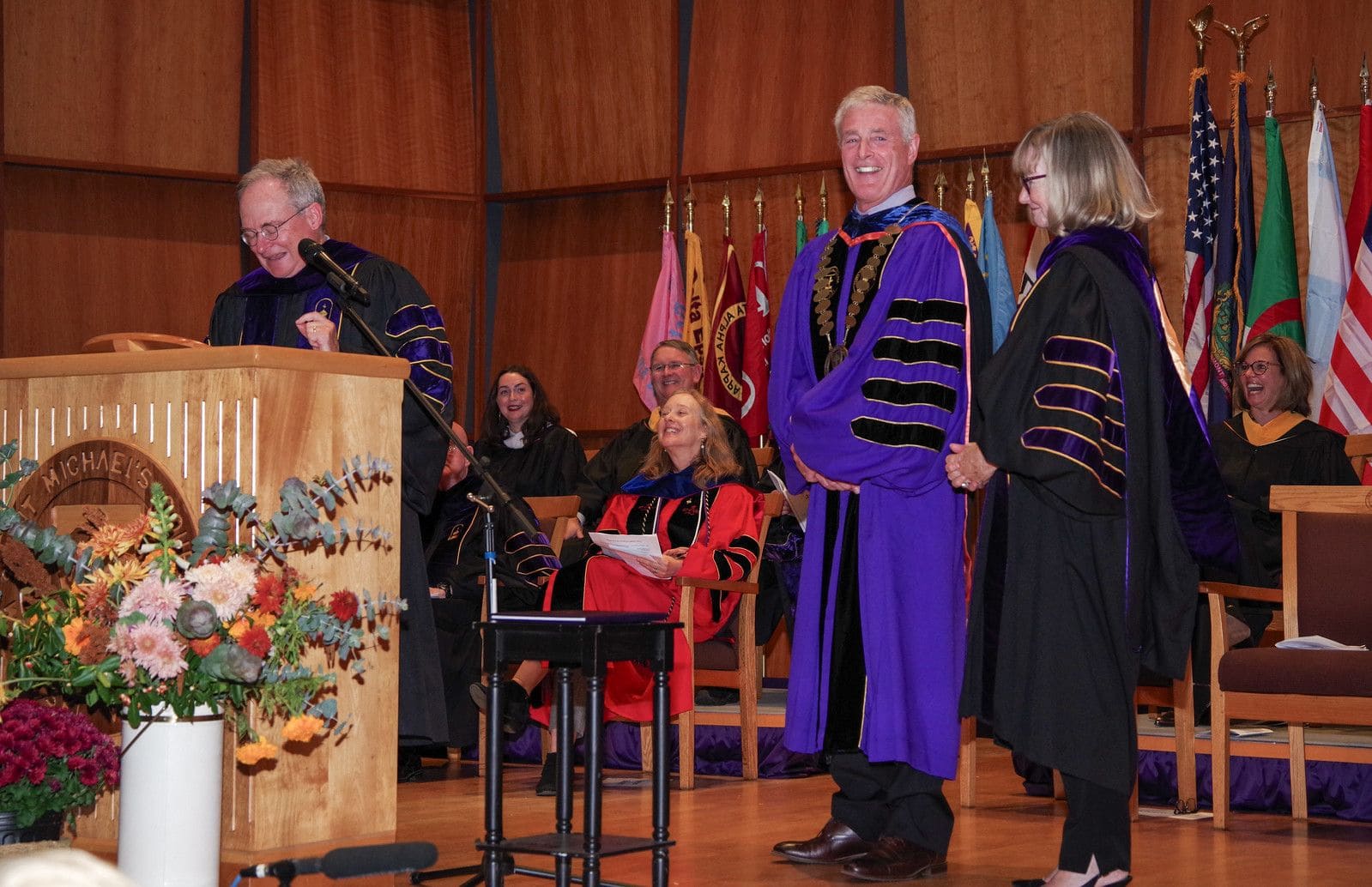 Saint Michael's College President Richard Plumb is officially bestowed the title of president by Board of Trustees Chair Rob Noonan, left, and former Chair Pat Casey during Plumb's Inauguration Ceremony on Oct. 26, 2024. (Photo by Steve Mease) 