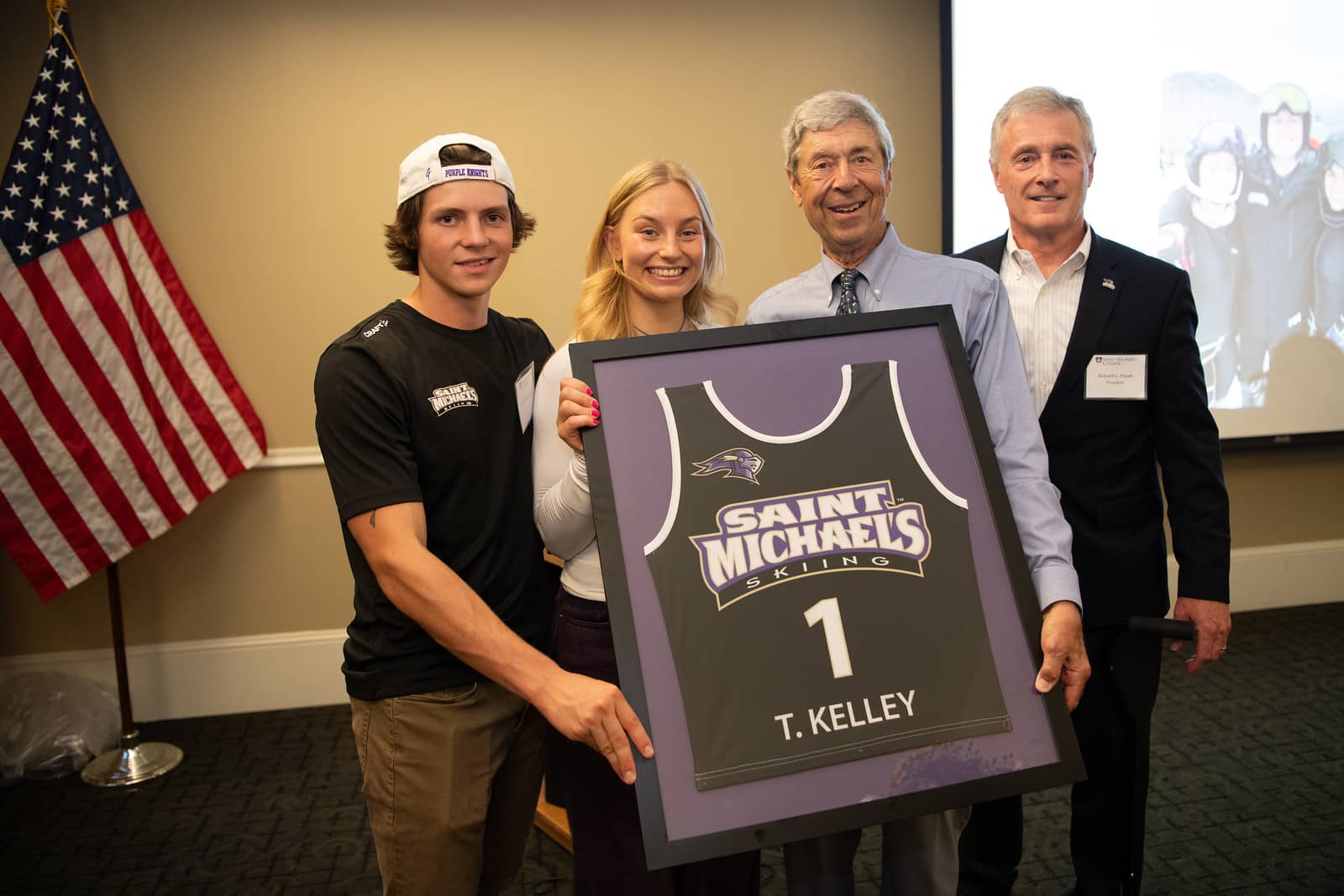 Maggie Frøland ’25 and Declan Hutchinson ’25, captains of the Alpine and Nordic Skiing Teams respectively, present Tom Kelley with a framed jersey during the grand opening of the Kelley Ski Center on Sept. 20, 2024. 